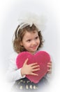 Young girl holding a plush pink heart